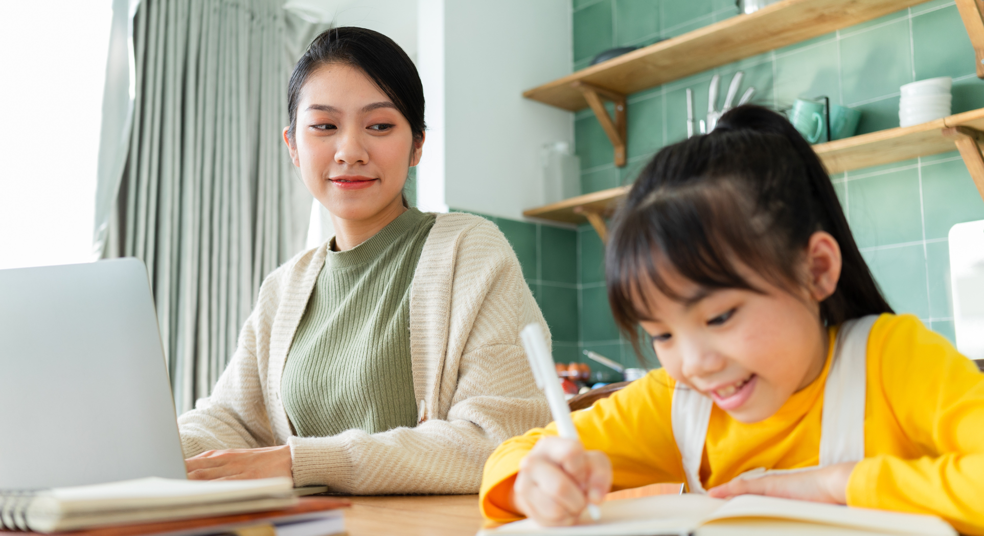 A parent proudly watching a child enthusiastically revise