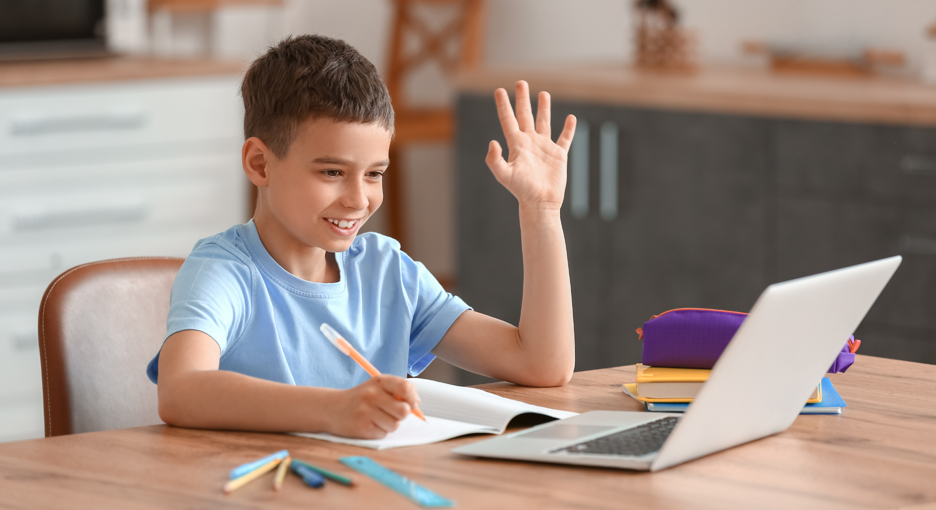 child revising happily for the 11 plus on his laptop