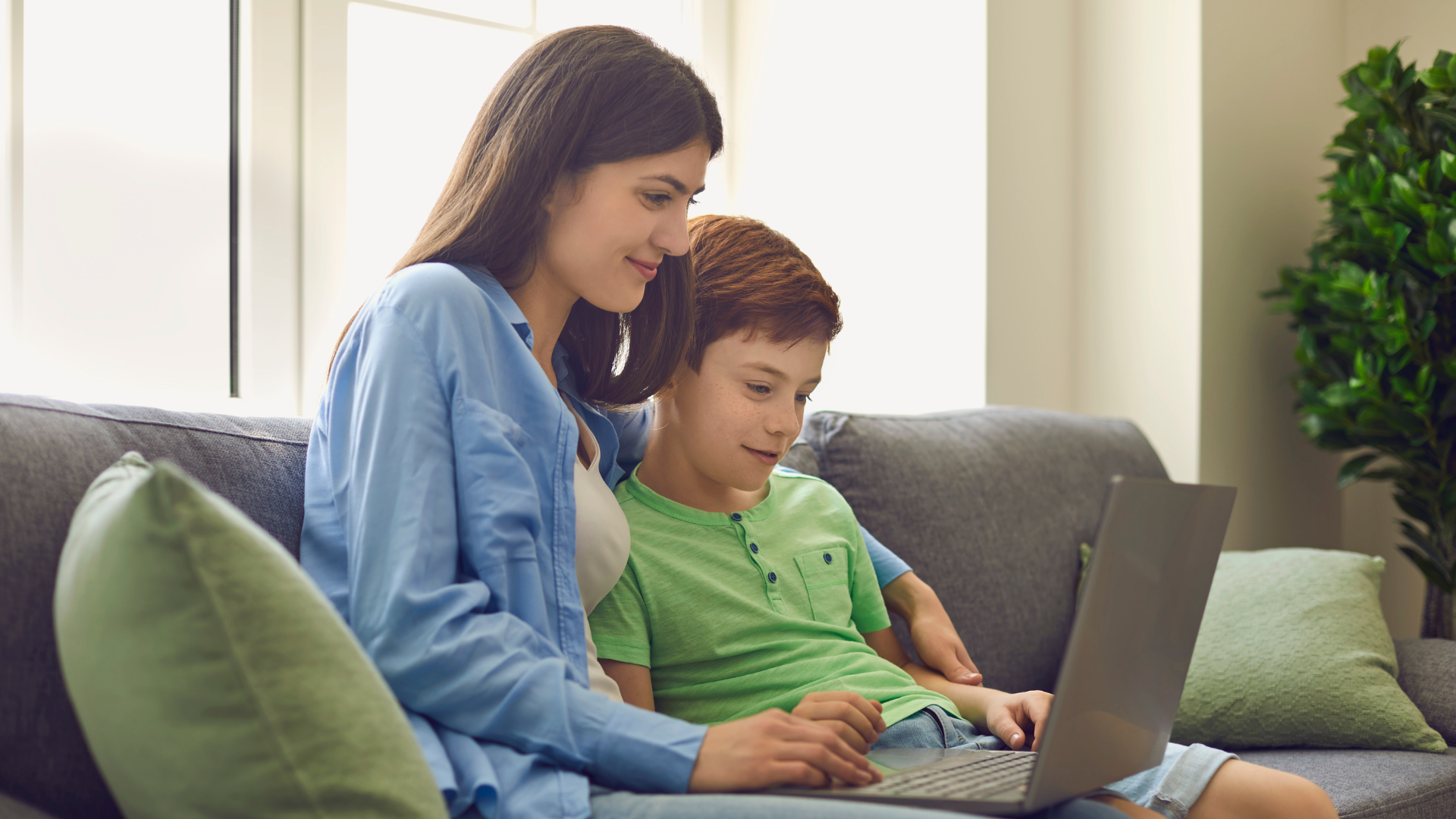 a parent and child revising together on a laptop