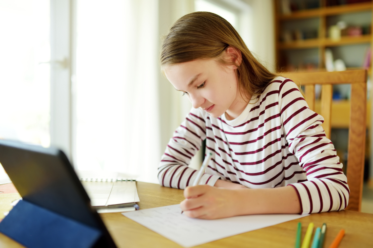 a child working hard on his laptop